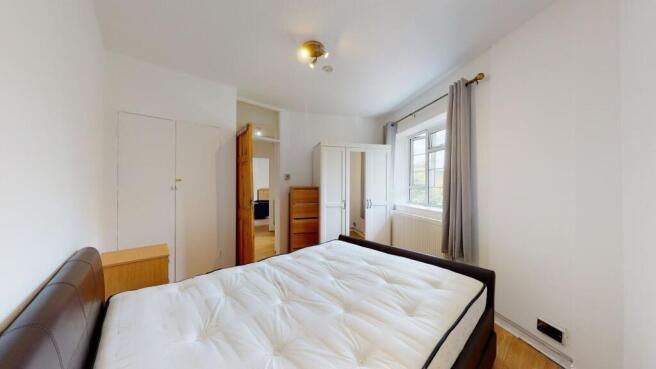Bright bedroom with ample storage and natural l...
