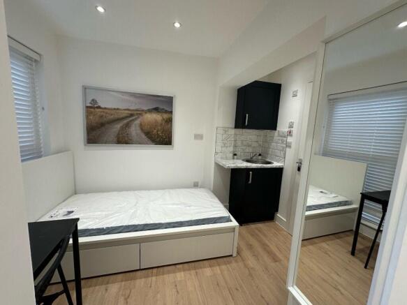 Neat, modern single bedroom with a built-in sto...