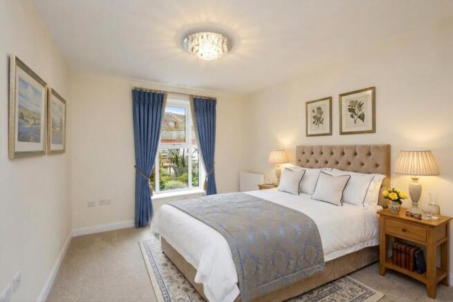 a bedroom with a bed and lamps