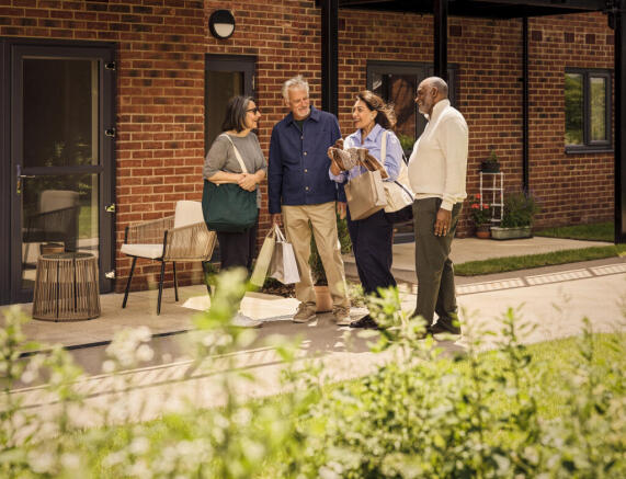 a group of people standing outside a brick building