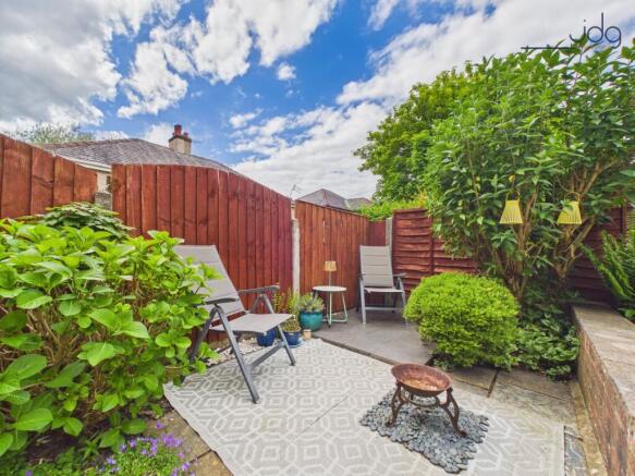 Tiered Garden with a mixture of flags, decking and lawn.