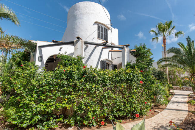 The garden and terraces extend all around the house