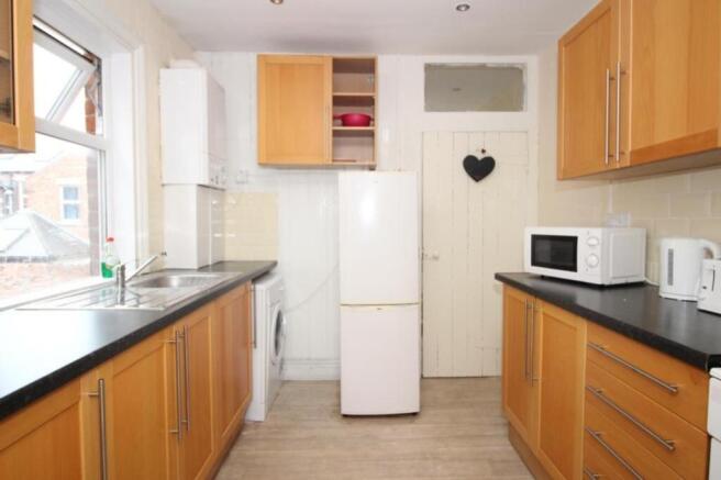 A bright and tidy kitchen featuring modern appl...