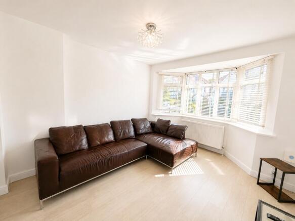 Bright living room with a large corner sofa...