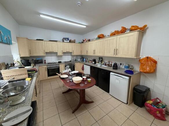 Spacious kitchen with ample storage and applian...