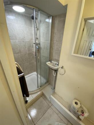 Bright bathroom with modern glass shower cubicl...