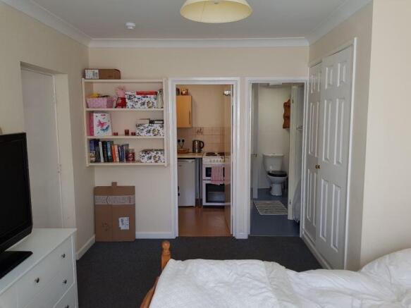 Bright bedroom with built-in storage and ensuit...