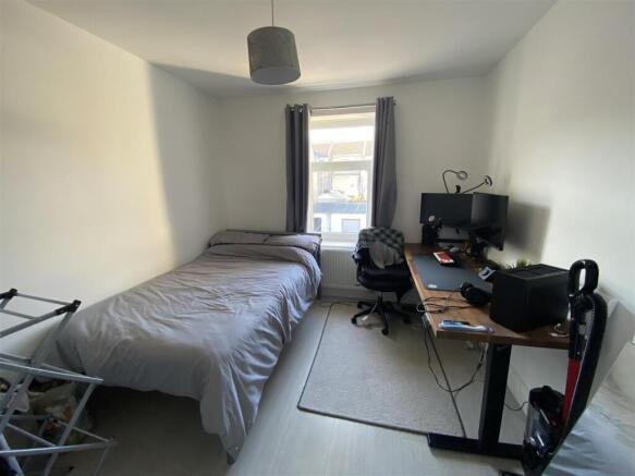Bright bedroom with large desk and double bed...