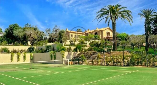 A luxurious villa with a tennis court in front, su