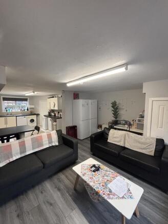 A modern, well-lit living room with comfortable...