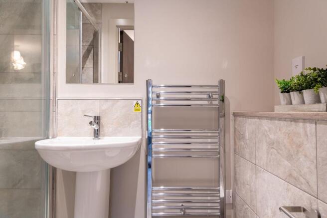 A modern bathroom featuring a clean white pedes...