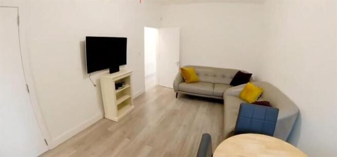 Bright living room with comfy sofas and TV...