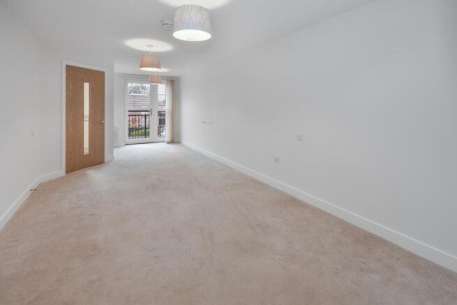 a room with a carpet and a ceiling fan