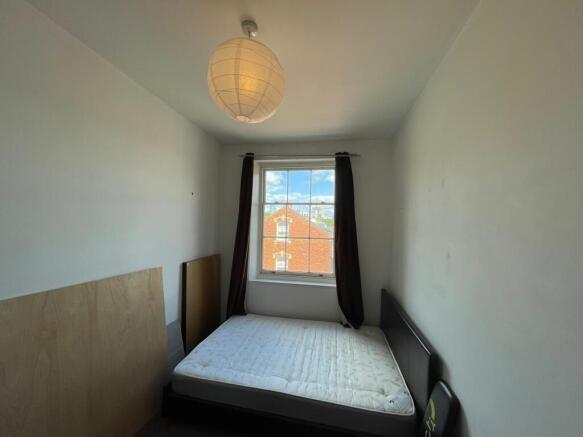 A simple double bedroom featuring a comfortable...