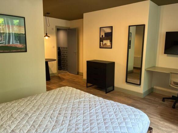 Stylish modern bedroom with integrated desk are...