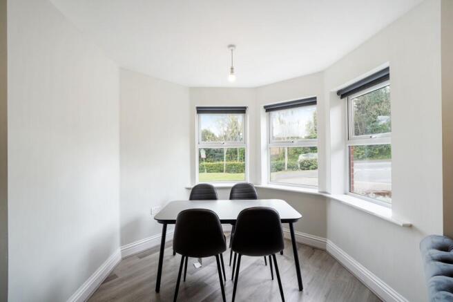 Bright dining area with large bay windows...
