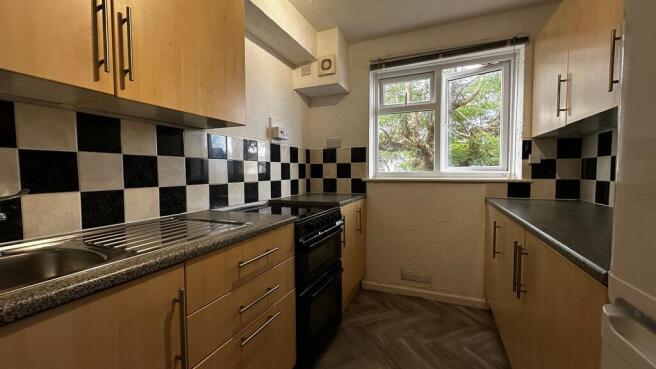 Bright kitchen with ample cabinet storage space...