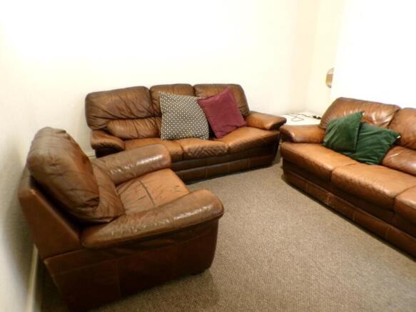 A cozy living room featuring comfortable leathe...