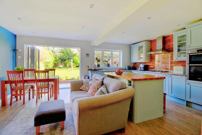 Kitchen features island with breakfast bar