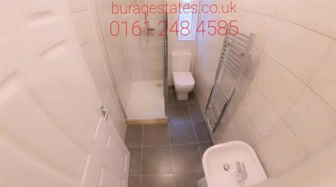 Compact, modern bathroom with white sanitarywar...