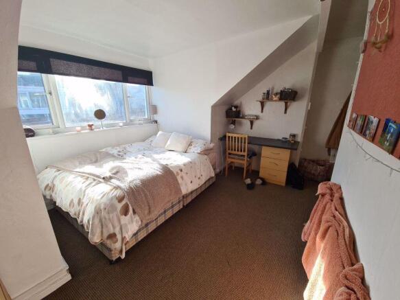 Bright and cozy double bedroom featuring a larg...