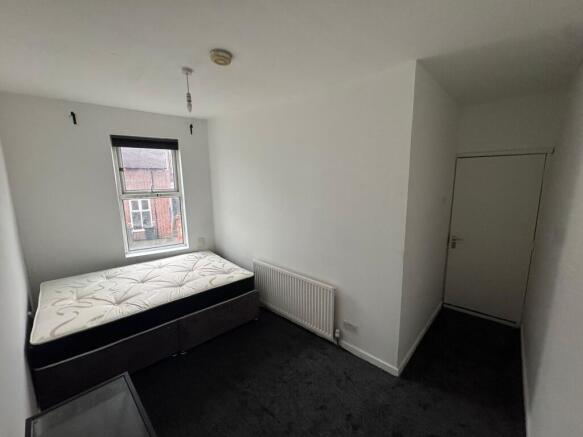 Compact, freshly painted single bedroom with a ...