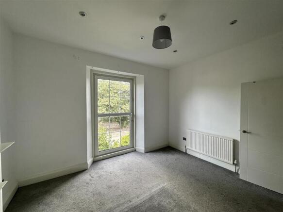Bright airy bedroom with large scenic window...