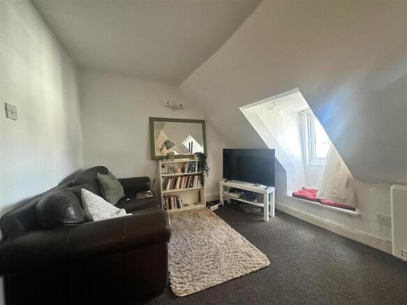Cosy lounge with plush leather sofa and TV setu...