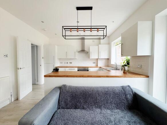 Bright, modern open-plan living area with a coz...