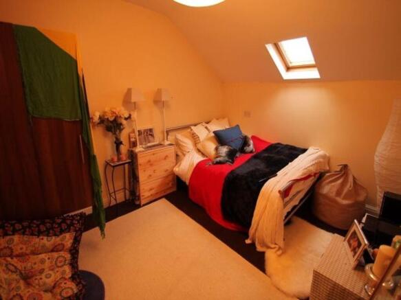 A spacious master bedroom featuring a large dou...