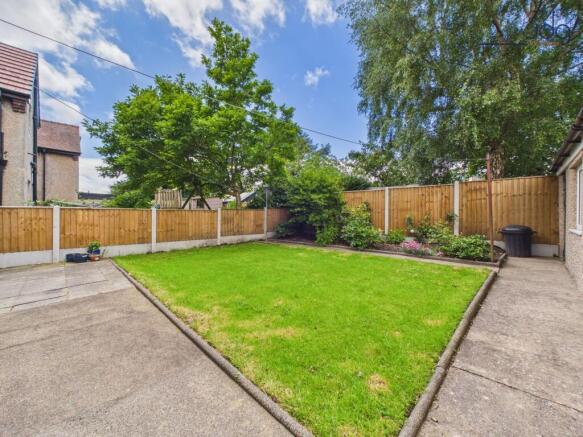 Private lawned garden with patio and mature planting