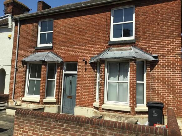 Charming red brick home with large bay windows...