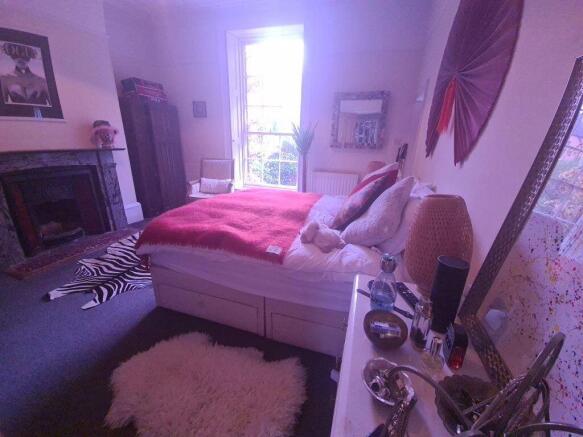 A spacious and well-maintained master bedroom f...