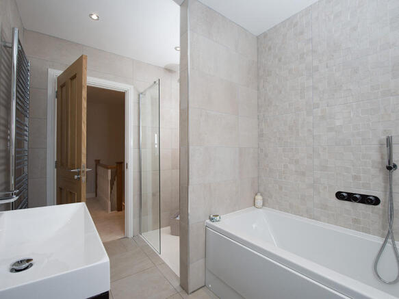 Extensively tiled family bathroom
