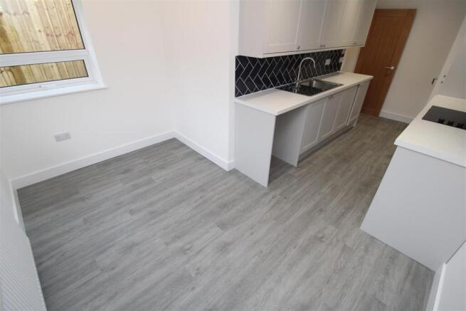 Bright modern kitchen with stylish wood floorin...