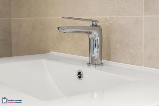 Close Up Of Sink Area In Family Bathroom
