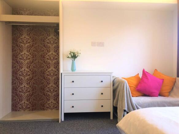 Bright and cozy double bedroom featuring a clea...