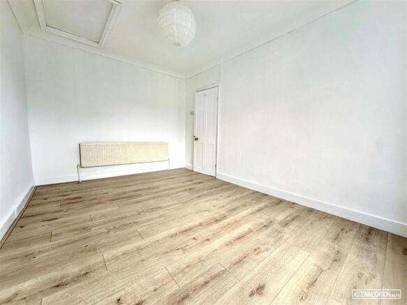 Bright and airy room with modern wood flooring...
