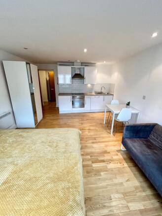 Modern studio with integrated kitchen and dinin...