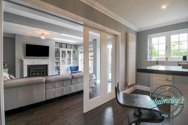 Concealed sliding doors between kitchen & family r