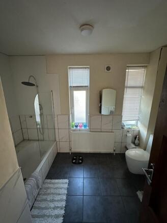 Bright, modern bathroom with a full-size bathtu...