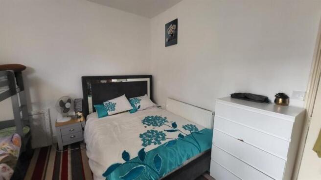 A cozy single bedroom featuring a comfortable b...