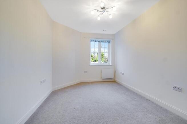 a room with a window and a carpet