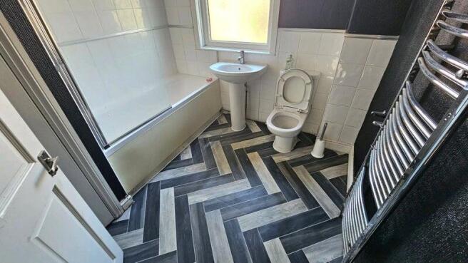 A well-maintained bathroom featuring a large ba...