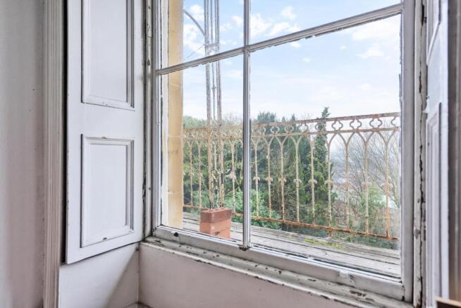Shuttered sash windows and balcony