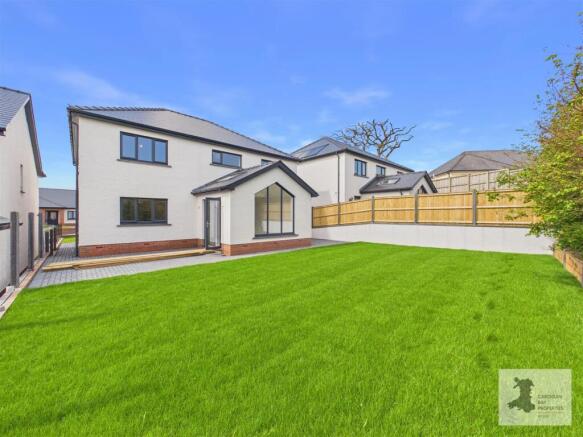 Rear garden and view of house