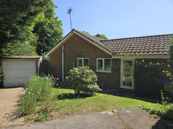 Garage, driveway and side garden