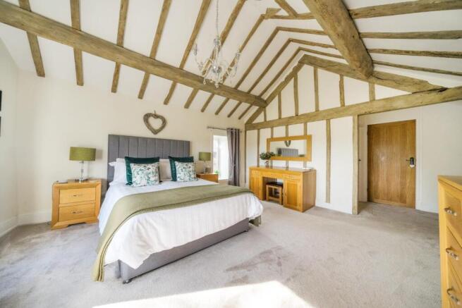 Bedroom 1 with ceiling beams.jpg