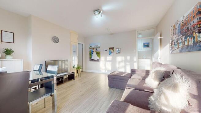 Bright, modern living room with a large L-shape...