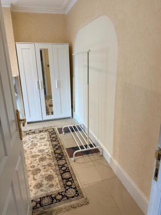 Bright hallway with ample storage and large rug...